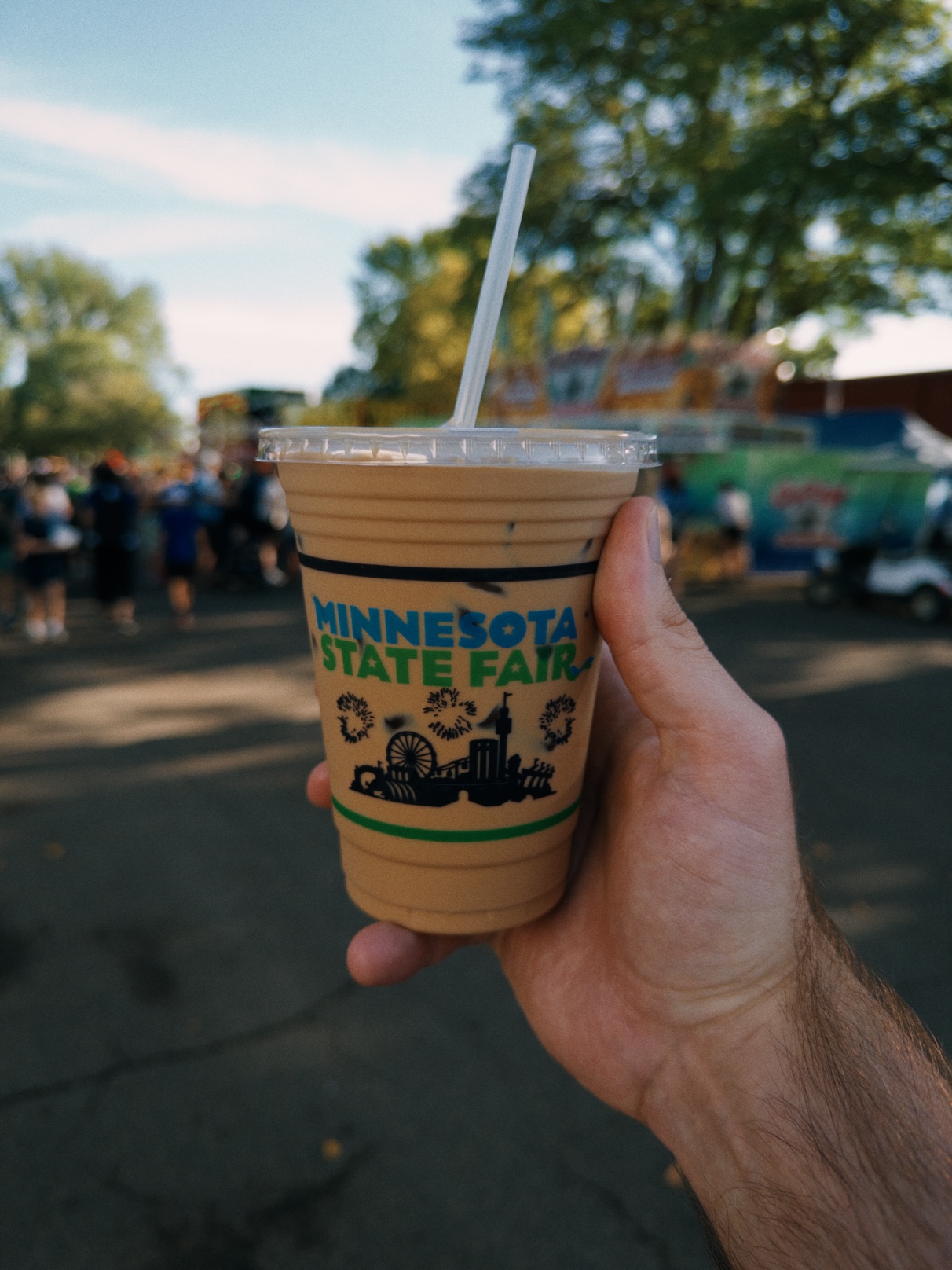 Light brown iced coffee in a clear plastic cup with the Minnesota State Fair wordmark on it