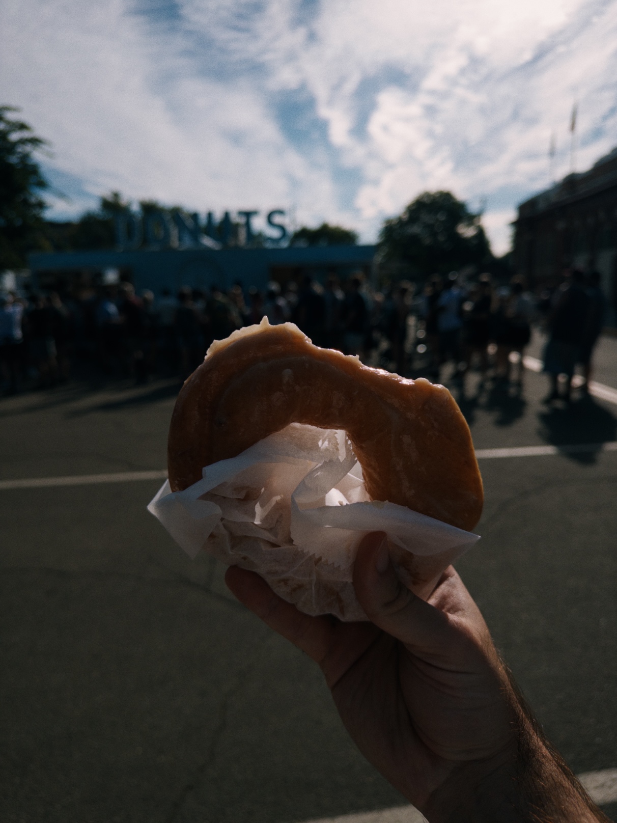 Large glazed ring doughnut with a bite taken out