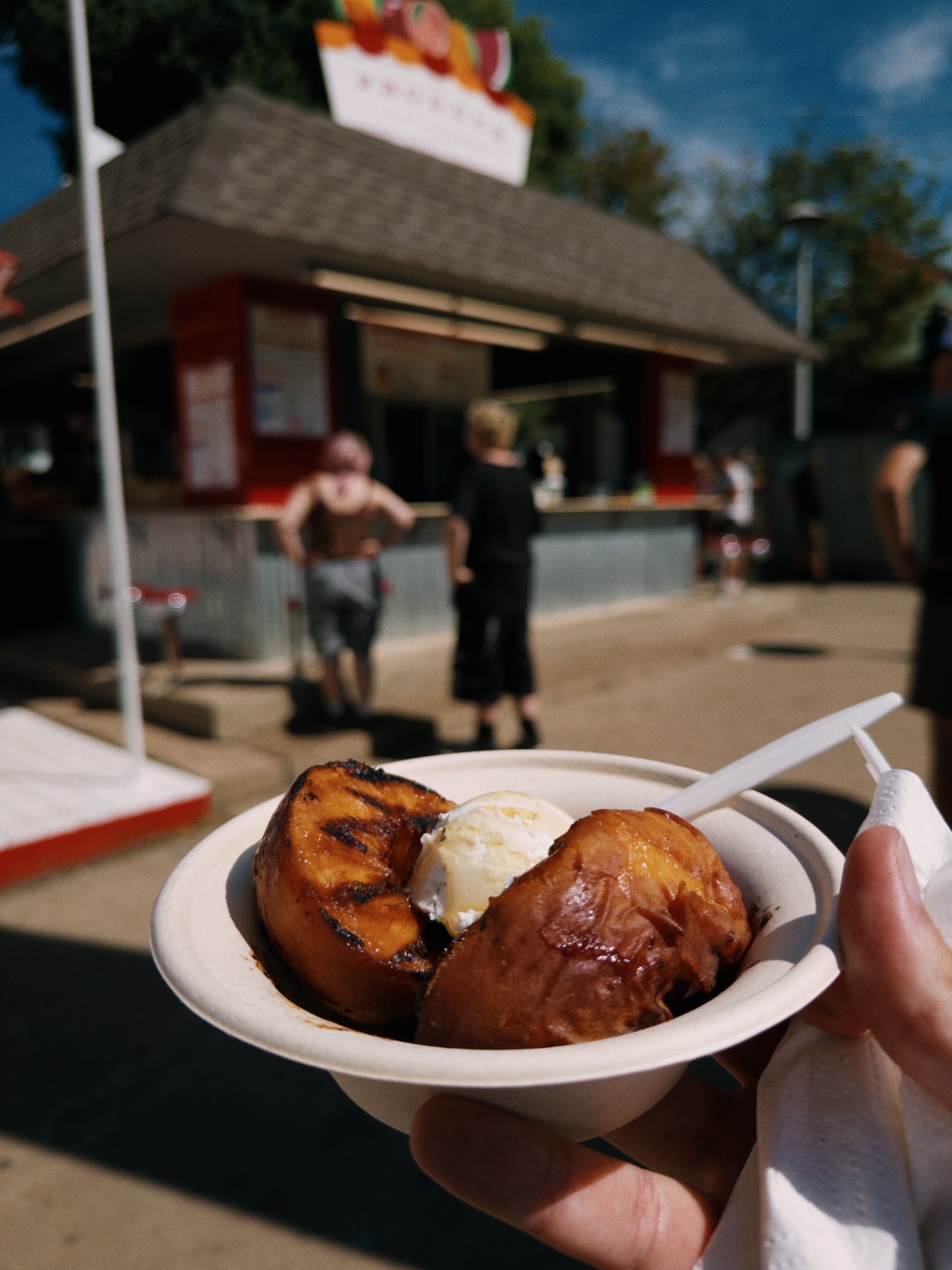 Two browned peach halves with a small mound of goat butter in the middle