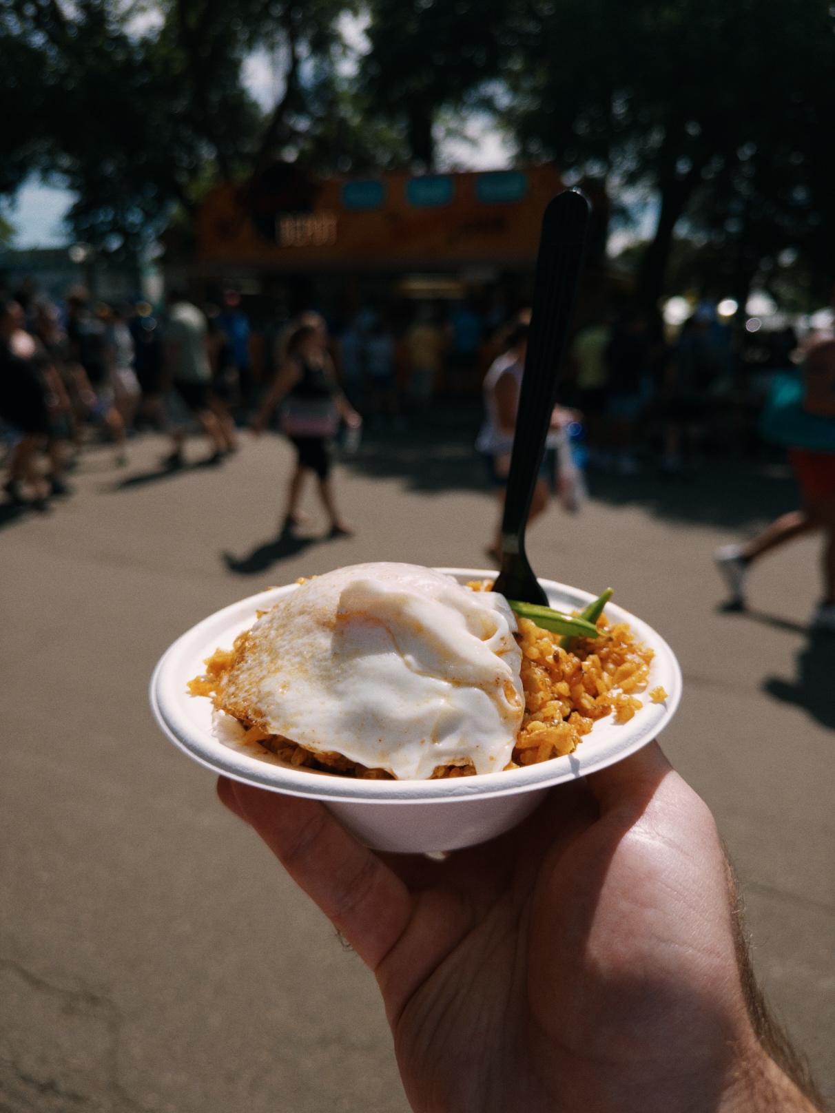 Orange rice topped with a fried egg and green pepper