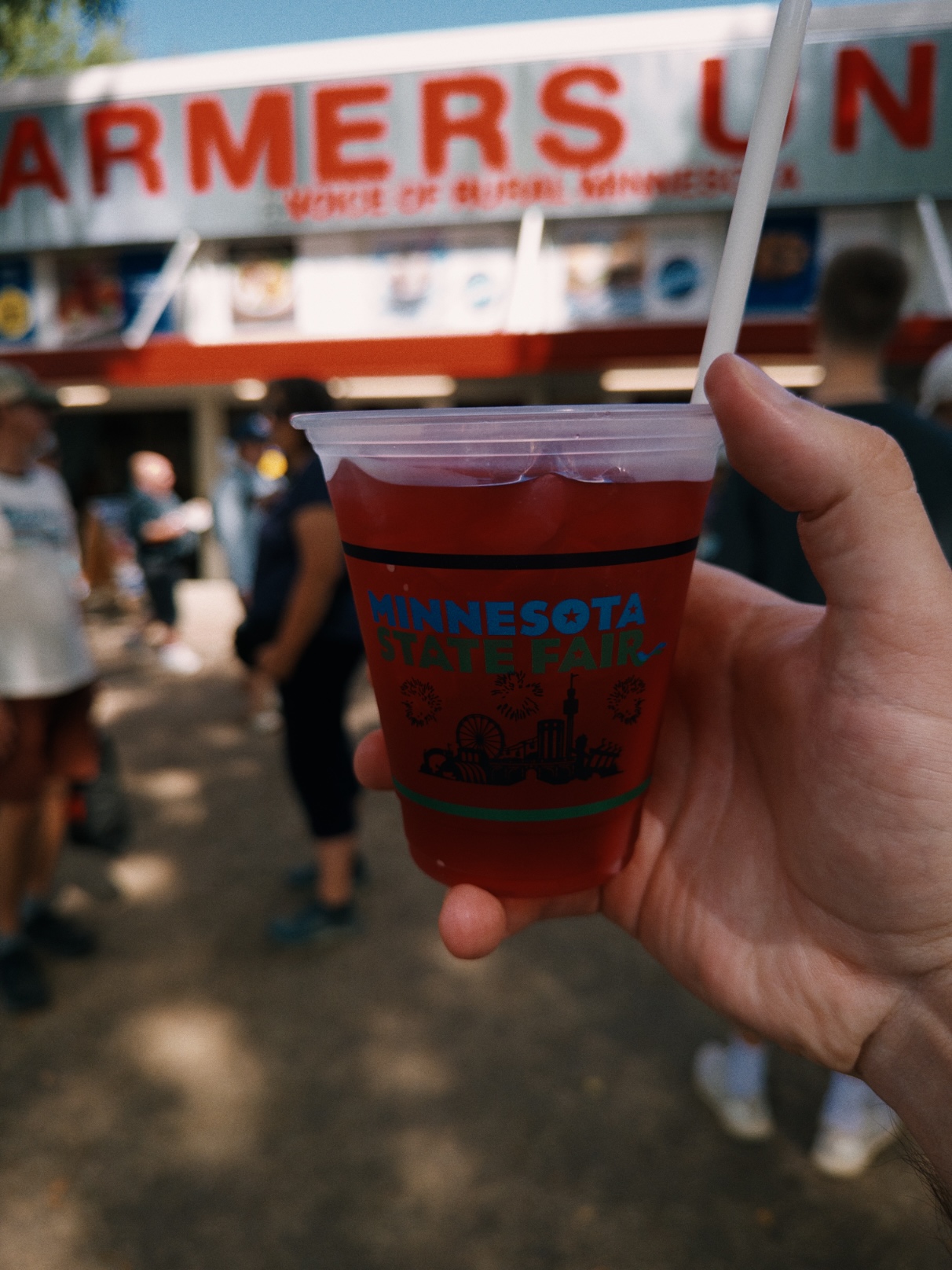Bright red iced drink in a clear plastic cup