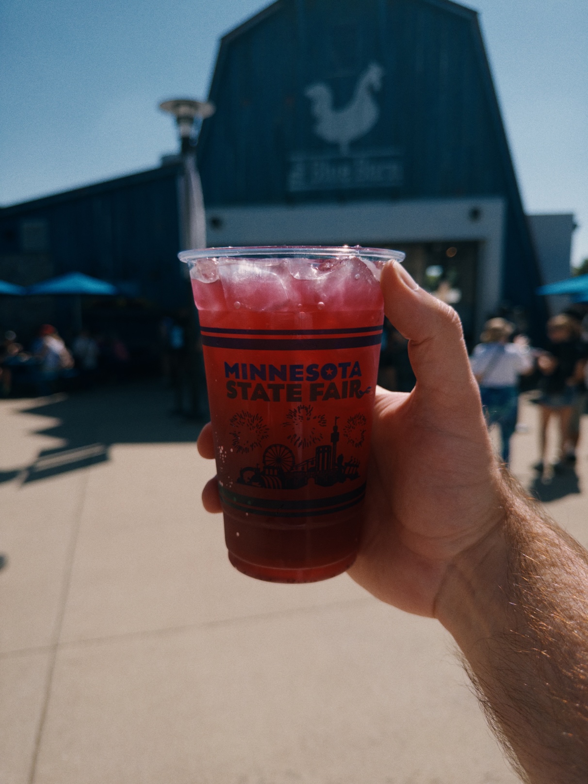 Deep pink iced drink in a clear plastic cup