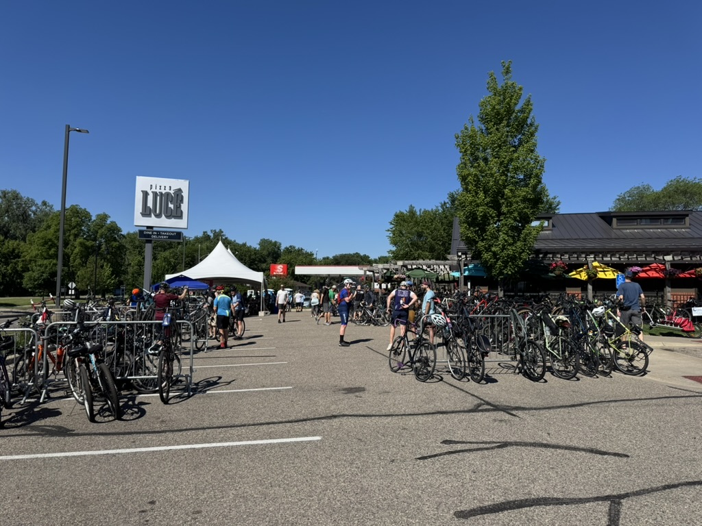 The parking lot of a Pizza Lucé location during the Tour de Lucé, filled with bikes